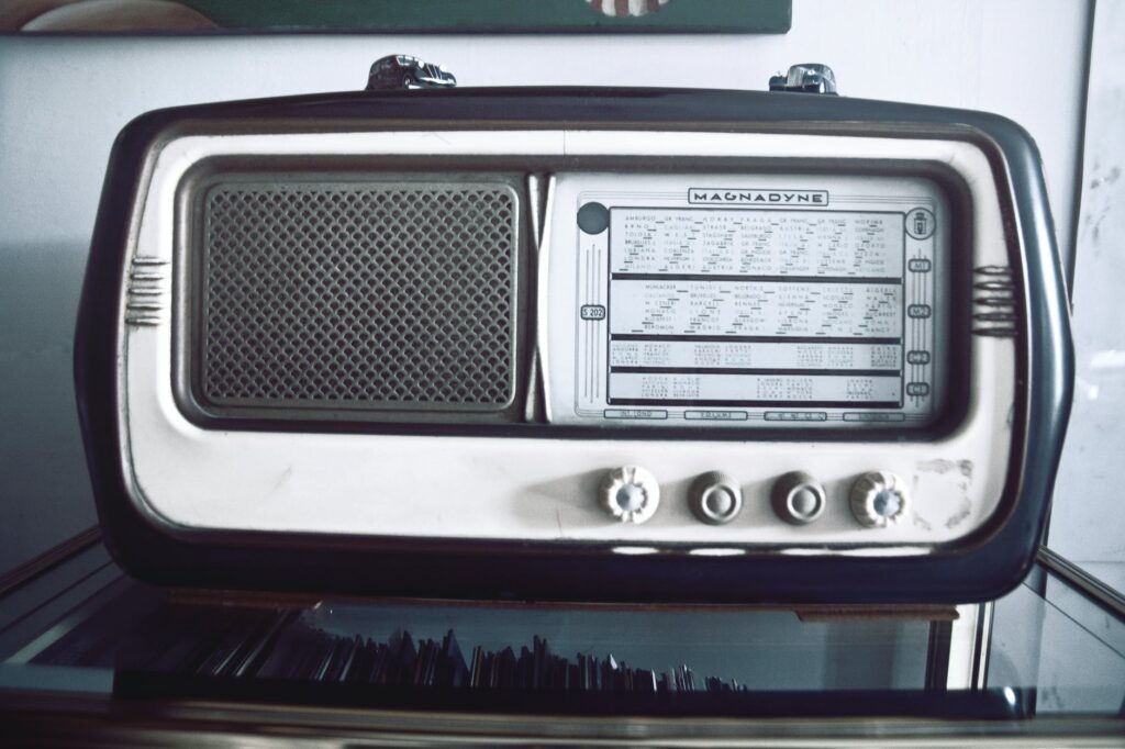 grayscale photography of gray and black magnadyne transistor radio